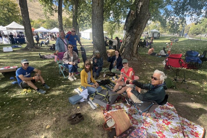 Guests relaxing under the trees at the Golden Wine Festival
