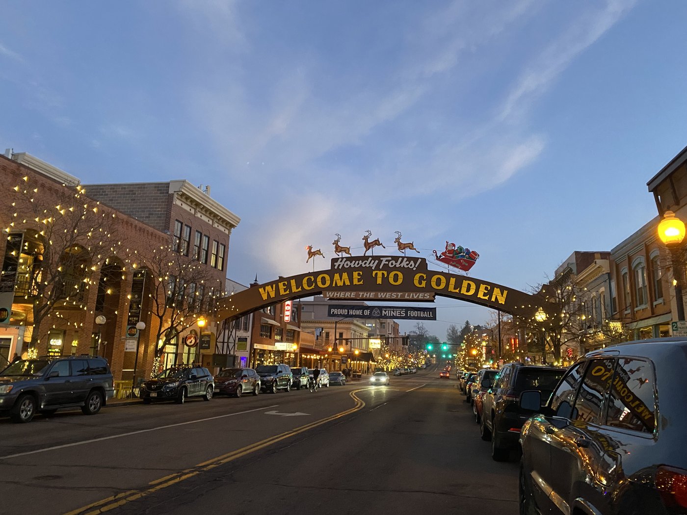 The Welcome to Golden arch over Washington Avenue at dusk